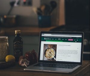 silver MacBook beside red pepper